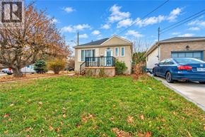 Hamilton apartment for rent - A house with a blue car parked in front.