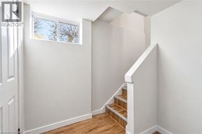 Hamilton apartment for rent - A white room with a staircase leading to the second floor.