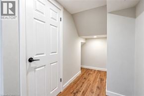 Hamilton apartment for rent - A white door with a black handle is in a room with white walls and wood flooring.