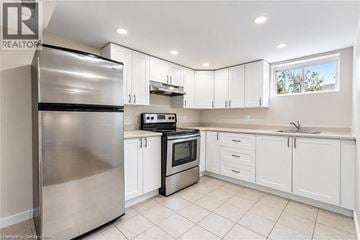 Hamilton apartment for rent - A modern kitchen with white cabinets and stainless steel appliances.