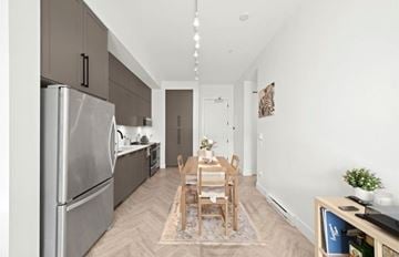 Surrey apartment for rent - A modern kitchen with a dining table set for two.