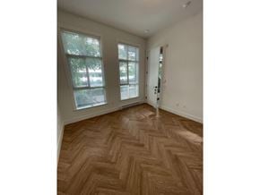 Surrey apartment for rent - A room with a chevron patterned wooden floor and a door.