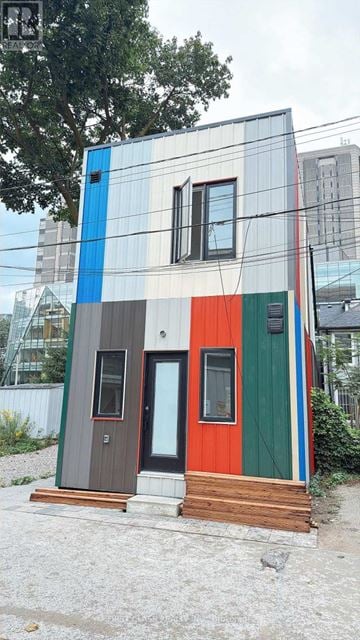 Toronto (University) apartment for rent - A small house with a blue, grey, green, and red exterior.
