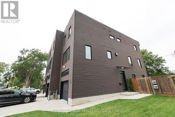 Welland (Lincoln/Crowland) townhouse for rent - A modern brown building with a black car parked in front.