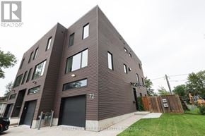 Welland (Lincoln/Crowland) townhouse for rent - A modern building with a dark facade and a number 72 on the front door.