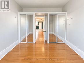 Toronto (Dovercourt-Wallace Emerson-Junction) apartment for rent - A room with a wooden floor and white walls, with a sliding door in the middle.