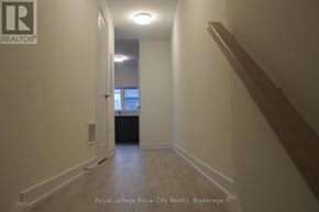 Guelph (Clairfields/Hanlon Business Park) townhouse for rent - A hallway with a Royal LePage logo on the wall.