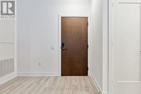 Toronto (Banbury-Don Mills) condo for rent - A room with a wooden door and white walls.