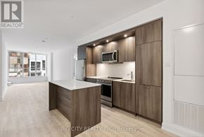 Toronto (Banbury-Don Mills) condo for rent - A modern kitchen with wooden cabinets and a central island.