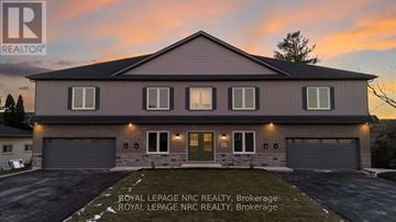 Thorold (Thorold Downtown) multi-family for rent - A house with a sign that says "Royal LePage NRC REALTY, Brokerage" in front of it.