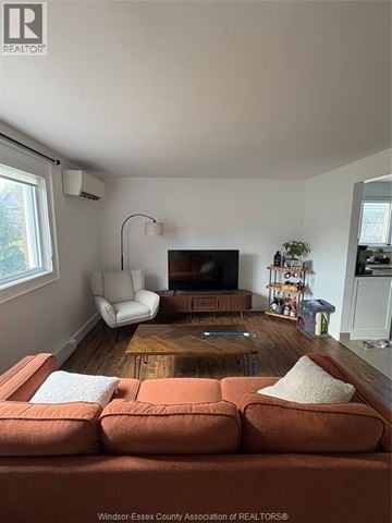Windsor apartment for rent - A living room with a brown couch and a wooden coffee table.