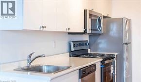 Brantford condo for rent - A kitchen with a stove, sink, and refrigerator.
