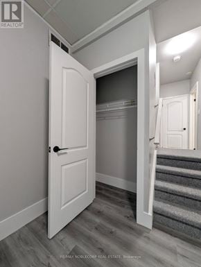 Barrie (Letitia Heights) townhouse for rent - A white door is open to a hallway with a staircase.