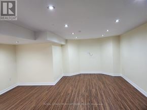 Milton (Be Beaty) apartment for rent - A room with wooden flooring and white walls.