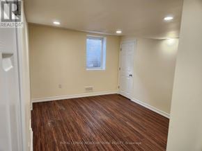 Milton (Be Beaty) apartment for rent - A room with wooden flooring and a window with blinds.