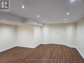 Milton (Be Beaty) apartment for rent - A room with wooden flooring and white walls.