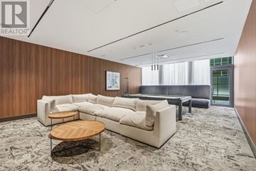 Milton (Tm Timberlea) condo for rent - A living room with a large sectional sofa, a coffee table, and a rug.