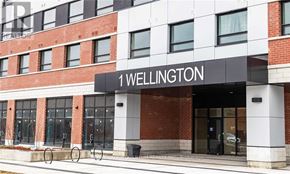 Brant (Brantford Twp) condo for rent - The front of a building with the name "1 Wellington" on it.