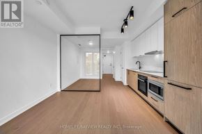 Toronto (Forest Hill South) condo for rent - A spacious kitchen with wooden cabinets and a large mirror on the wall.
