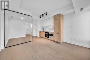 Toronto (Forest Hill South) condo for rent - A spacious kitchen with wooden cabinets and a large island.