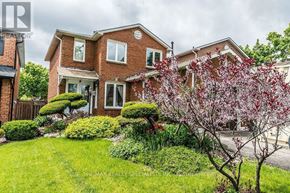 Mississauga (Hurontario) apartment for rent - A house with a red brick exterior and a green lawn.