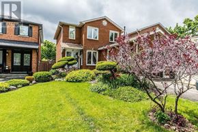Mississauga (Hurontario) apartment for rent - A house with a red brick exterior and a green lawn.