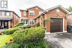 Mississauga (Hurontario) apartment for rent - A house with a brown garage door and a sign that says REALTOR.
