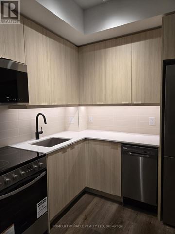 Milton (Tm Timberlea) apartment for rent - A kitchen with wooden cabinets and a black microwave.