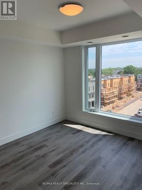 Waterloo condo for rent - A room with a large window overlooking a construction site.
