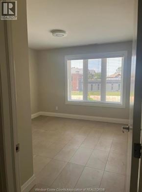 Windsor apartment for rent - A room with a sliding glass door leading to a balcony.