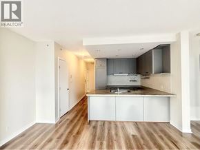 Vancouver apartment for rent - A kitchen with white cabinets and a wooden floor.