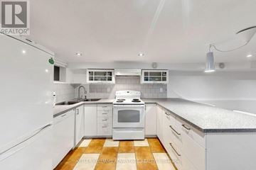 Toronto (Woodbine Corridor) apartment for rent - A white kitchen with a stove top oven and a refrigerator.