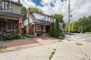 Toronto (Woodbine Corridor) apartment for rent - A house with a driveway and a flag in front of it.