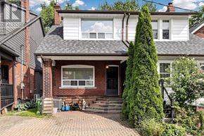 Toronto (Woodbine Corridor) apartment for rent - A house with a red brick wall and a white siding wall.