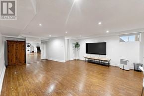 Toronto (Woodbine Corridor) apartment for rent - A spacious living room with hardwood floors and a flat-screen TV.