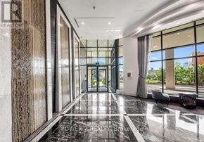 Vaughan (Crestwood-Springfarm-Yorkhill) condo for rent - A hallway with a marble floor and a glass wall on one side.
