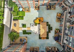 Vaughan (Crestwood-Springfarm-Yorkhill) condo for rent - An aerial view of a courtyard surrounded by buildings with a sign that reads "POWER 7 REALTY Brokerage".