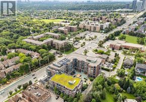 Vaughan (Crestwood-Springfarm-Yorkhill) condo for rent - An aerial view of a residential area with apartment buildings and green spaces.