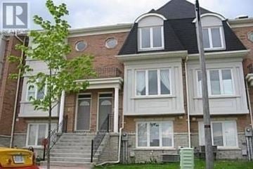 Markham (Commerce Valley) townhouse for rent - A two-story brick house with a black roof and white trim.