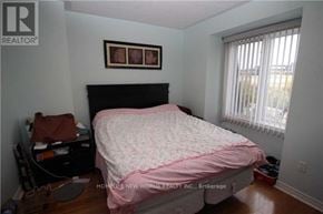 Markham (Commerce Valley) townhouse for rent - A bedroom with a pink bedspread and a black headboard.