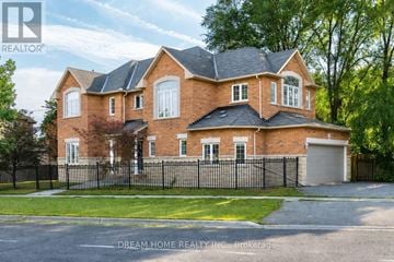 Toronto (Highland Creek) apartment for rent - A large brick house with a black fence in front.