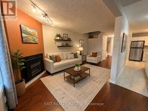 Ottawa townhouse for rent - A living room with a fireplace and a painting on the wall.