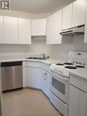 Pelham (Fenwick) apartment for rent - A white kitchen with a stainless steel dishwasher and white appliances.