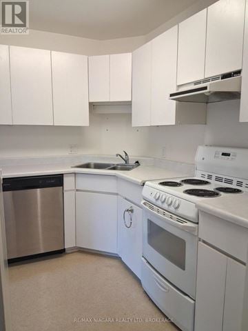 Pelham (Fenwick) apartment for rent - A white kitchen with a stainless steel dishwasher and white appliances.