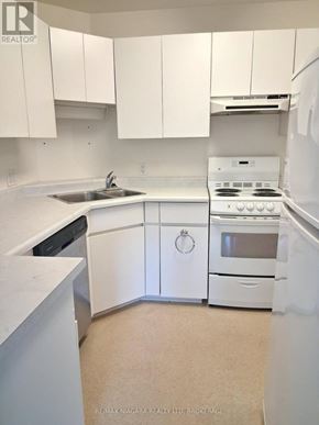 Pelham (Fenwick) apartment for rent - A white kitchen with a sink, stove, and cabinets.