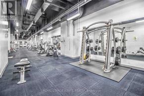 Toronto (Niagara) condo for rent - A gym with a variety of equipment including dumbbells and weight machines.