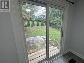 Toronto (Pleasant View) apartment for rent - A sliding glass door with a view of a backyard.