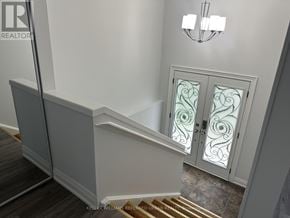 Toronto (Pleasant View) apartment for rent - A staircase with a glass door and a chandelier.