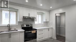 Toronto (Pleasant View) apartment for rent - A kitchen with a stove top oven and a sink.