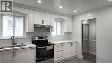 Toronto (Pleasant View) apartment for rent - A kitchen with a stove top oven and a sink.